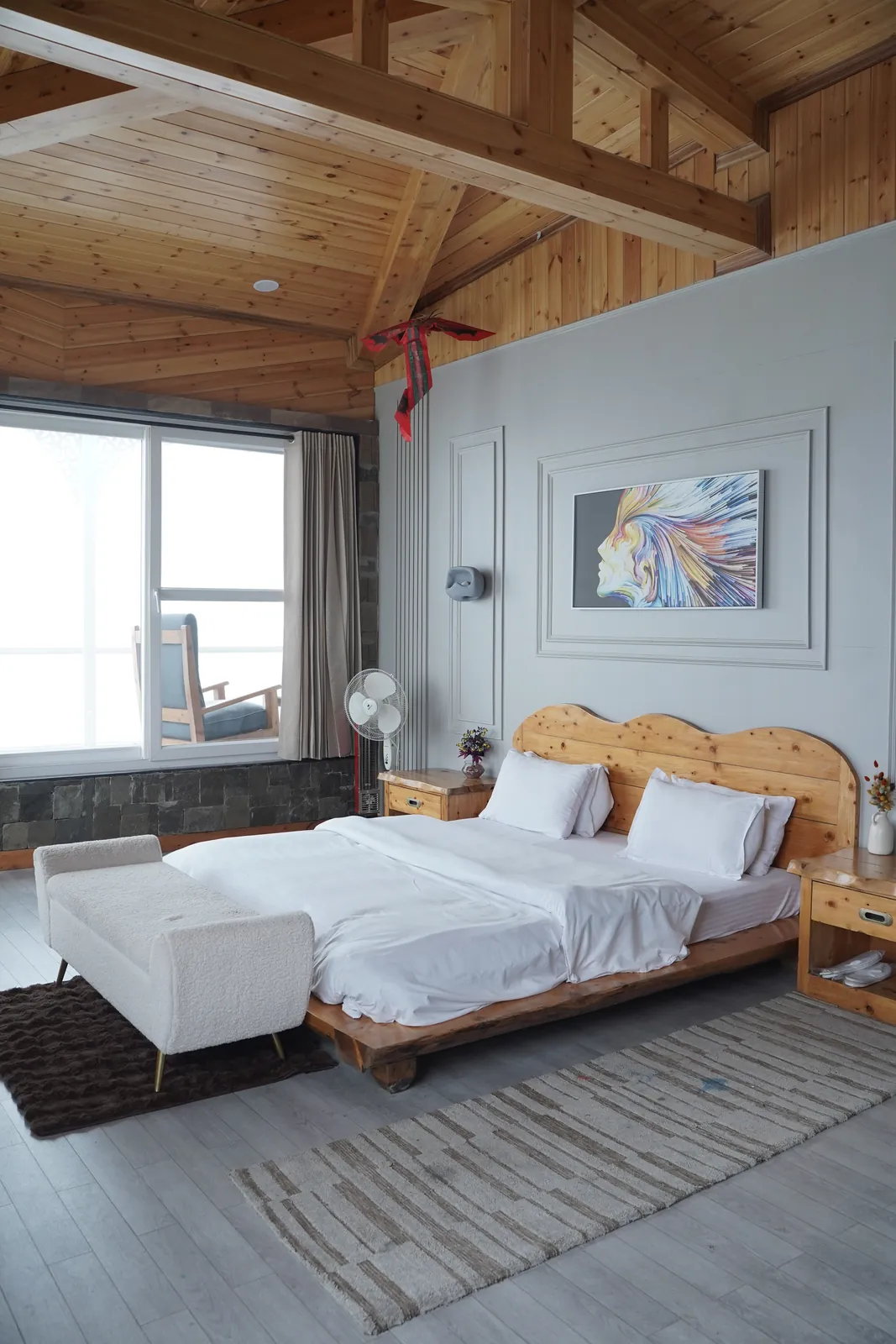 Twin-bed bedroom with white linen, wooden headboards and abstract wall art in The Kings Land 2BHK mountain villa, Suwakholi near Mussoorie