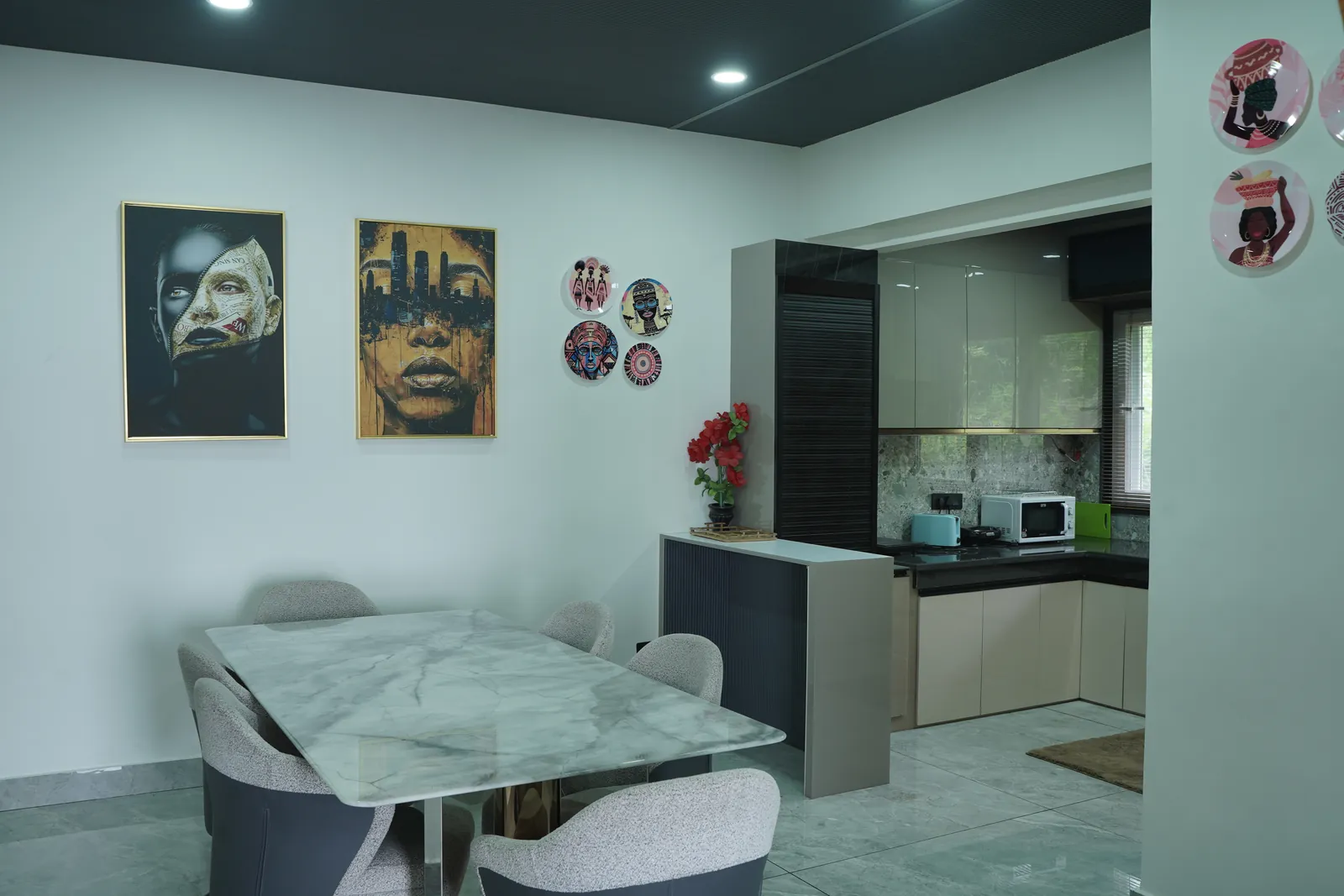 Dining area with marble table and modern kitchen with wall art in The Kings Land 2BHK family villa, Suwakholi, Mussoorie