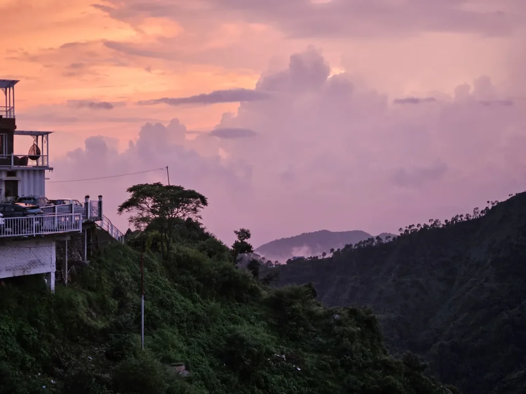 Pink and orange sunset sky over the Himalayan foothills from Highlanders Café & Stay, Suwakholi near Mussoorie, Uttarakhand